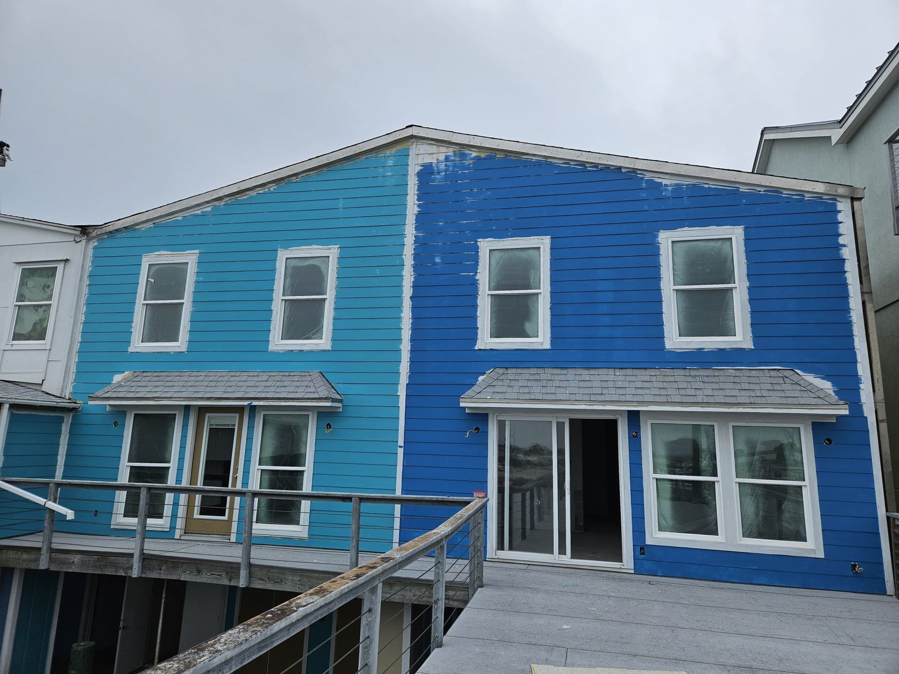 Twin blue coastal homes built by OP Construction & Development