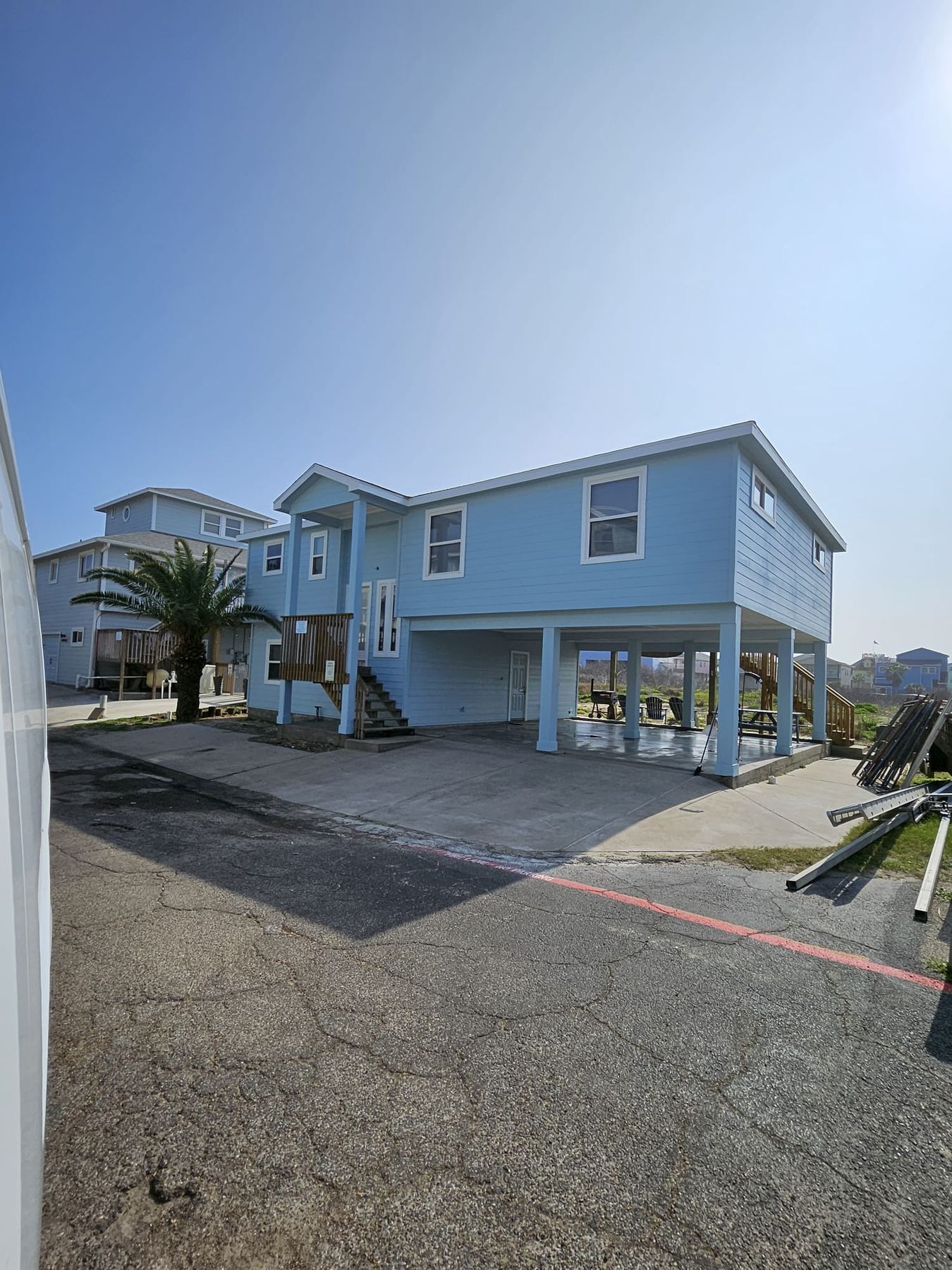 Cream three-story coastal home exterior by OP Construction & Development