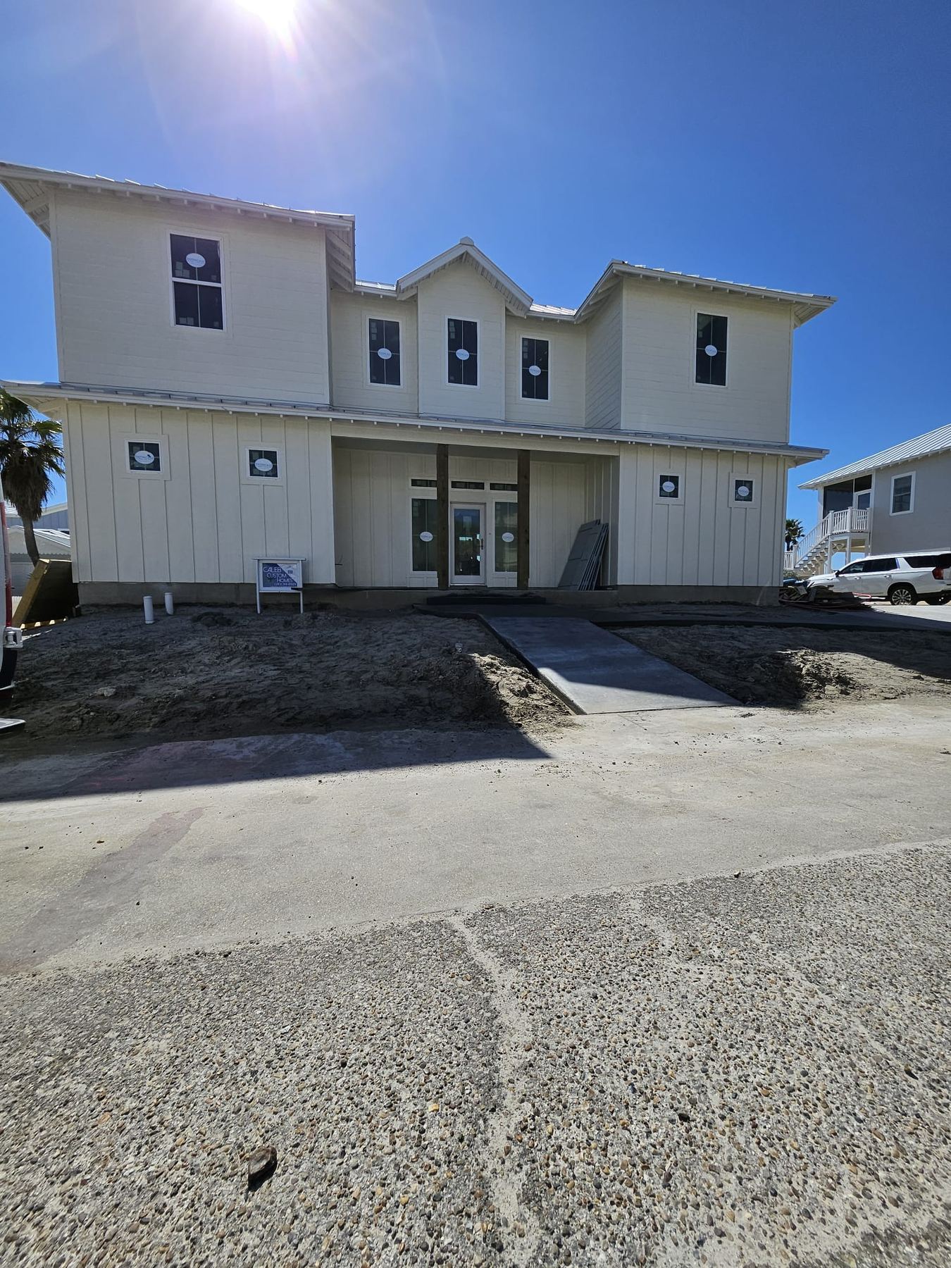 White three-story coastal home exterior