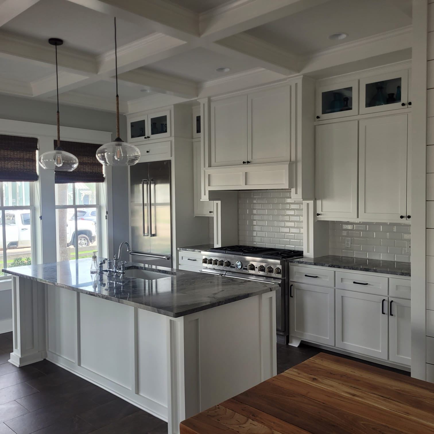 Kitchen remodel with white cabinets and black countertops