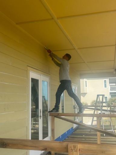 OP Construction & Development crew painting under the eaves
