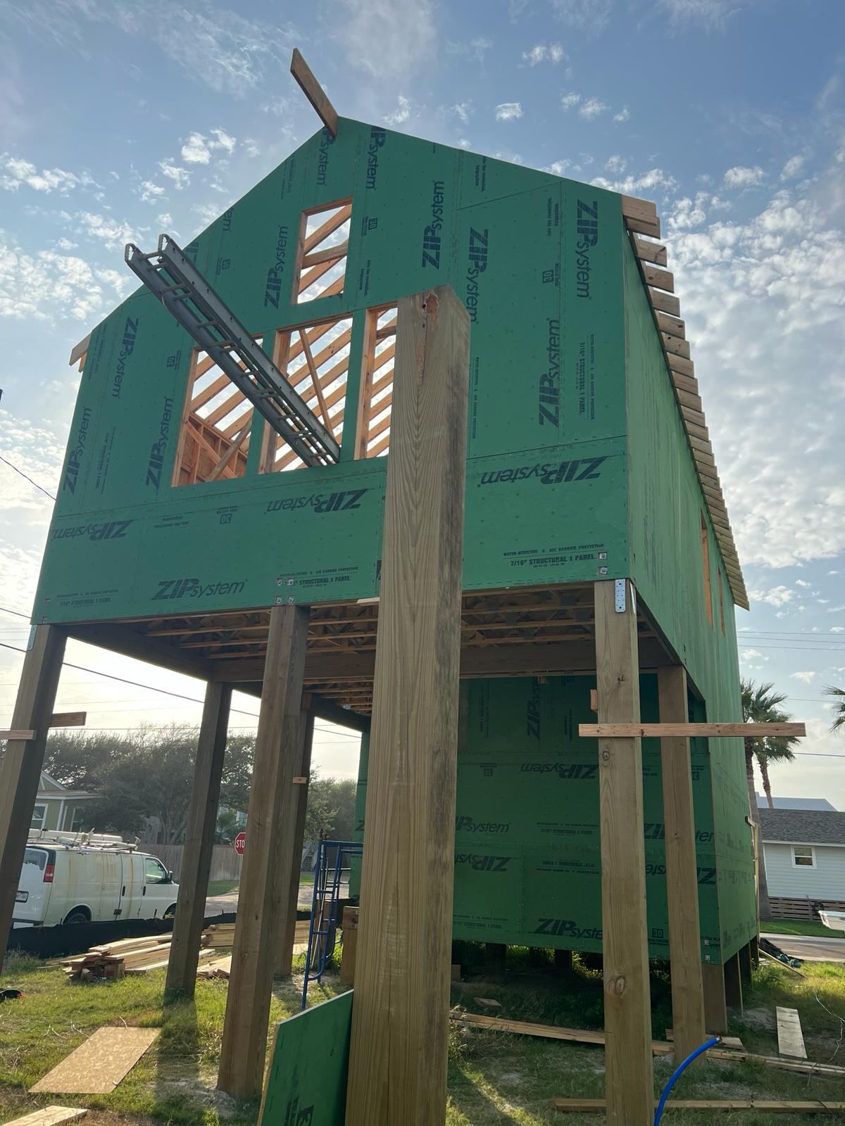 Coastal home under construction with house wrap